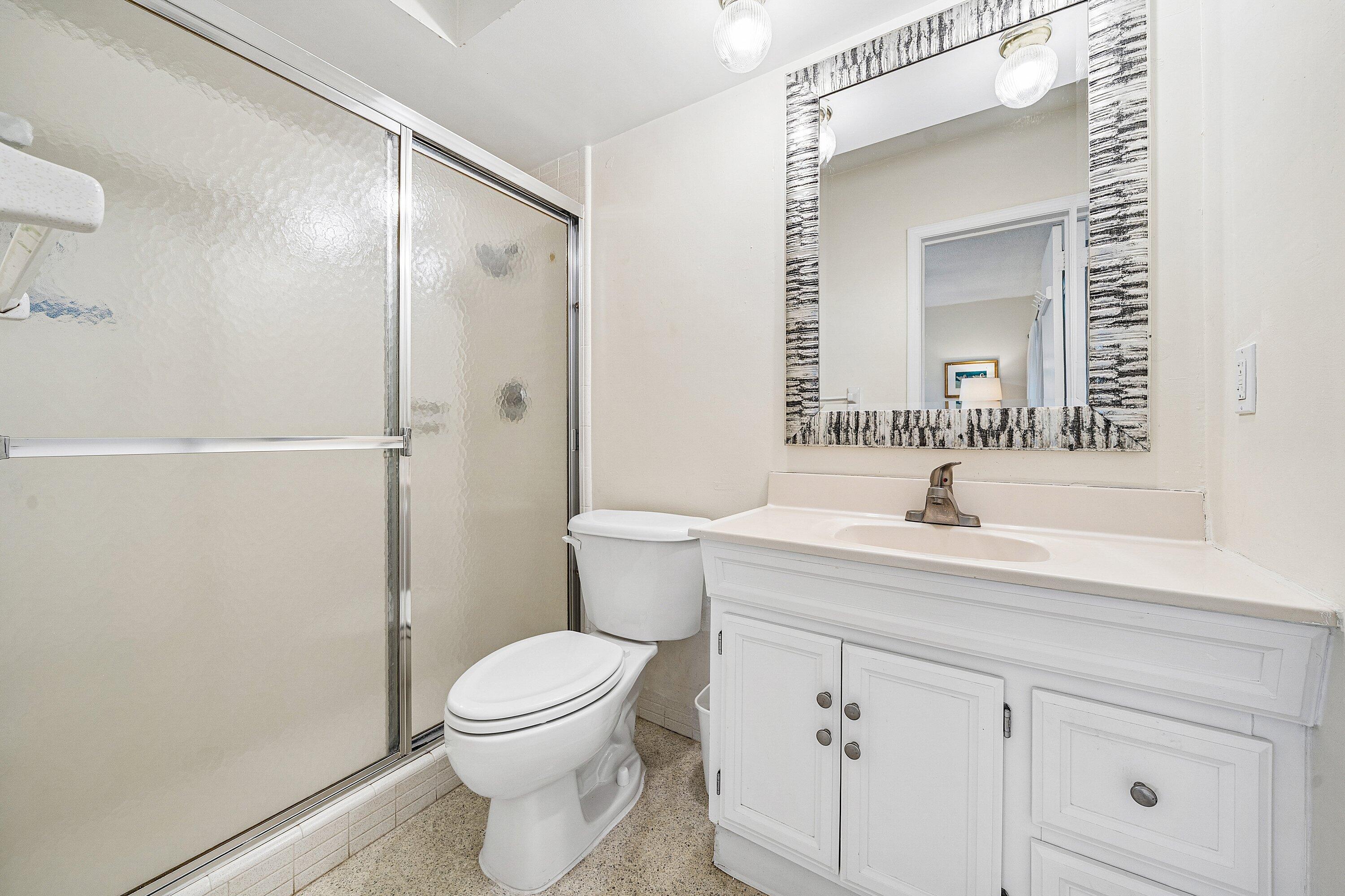 5550 Osprey Drive Ocean Ridge, FL 33435 - Photo 26 of 44 a bathroom with a toilet a sink a vanity and mirror