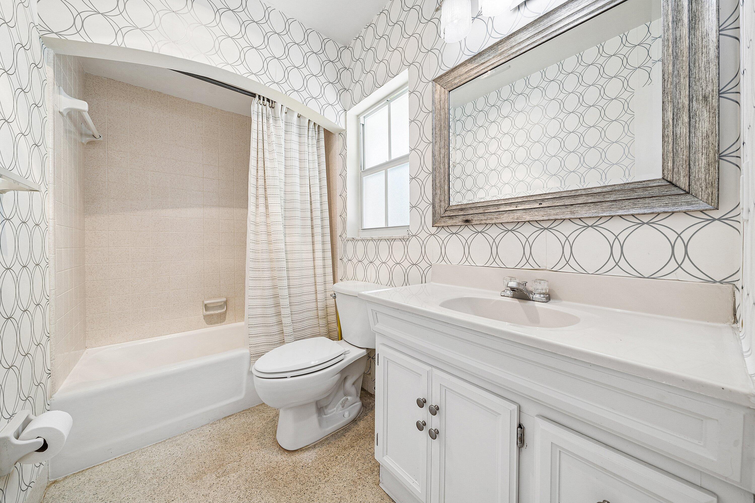 5550 Osprey Drive Ocean Ridge, FL 33435 - Photo 28 of 44 a bathroom with a sink toilet and shower