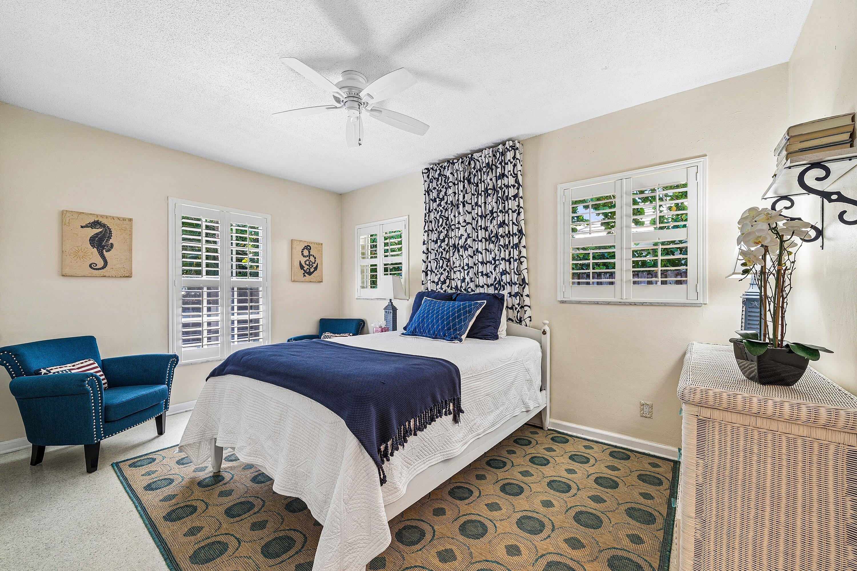 5550 Osprey Drive Ocean Ridge, FL 33435 - Photo 29 of 44 a bedroom with a bed a couch and a window