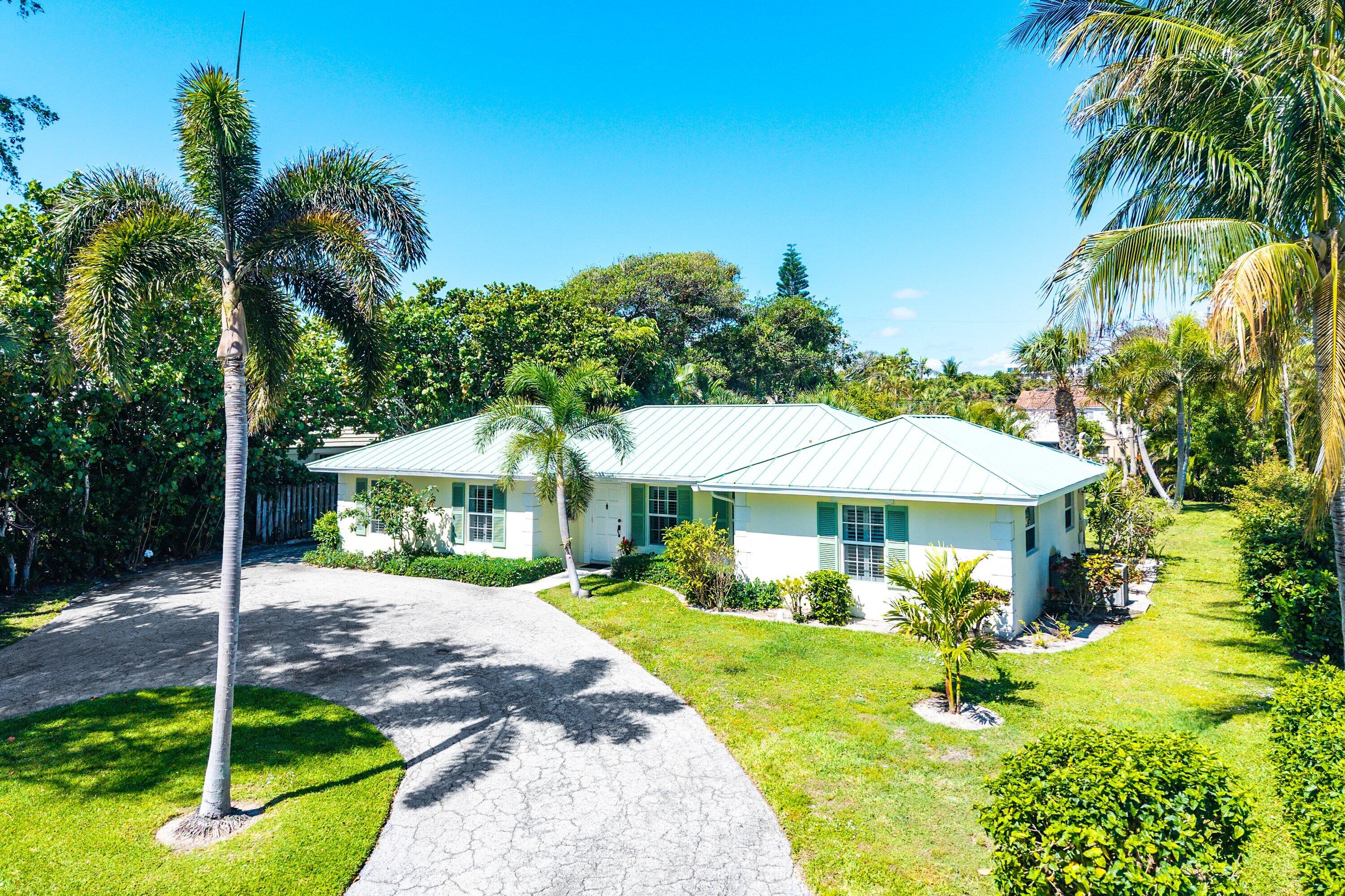 5550 Osprey Drive Ocean Ridge, FL 33435 - Photo 37 of 44 a front view of a house with garden