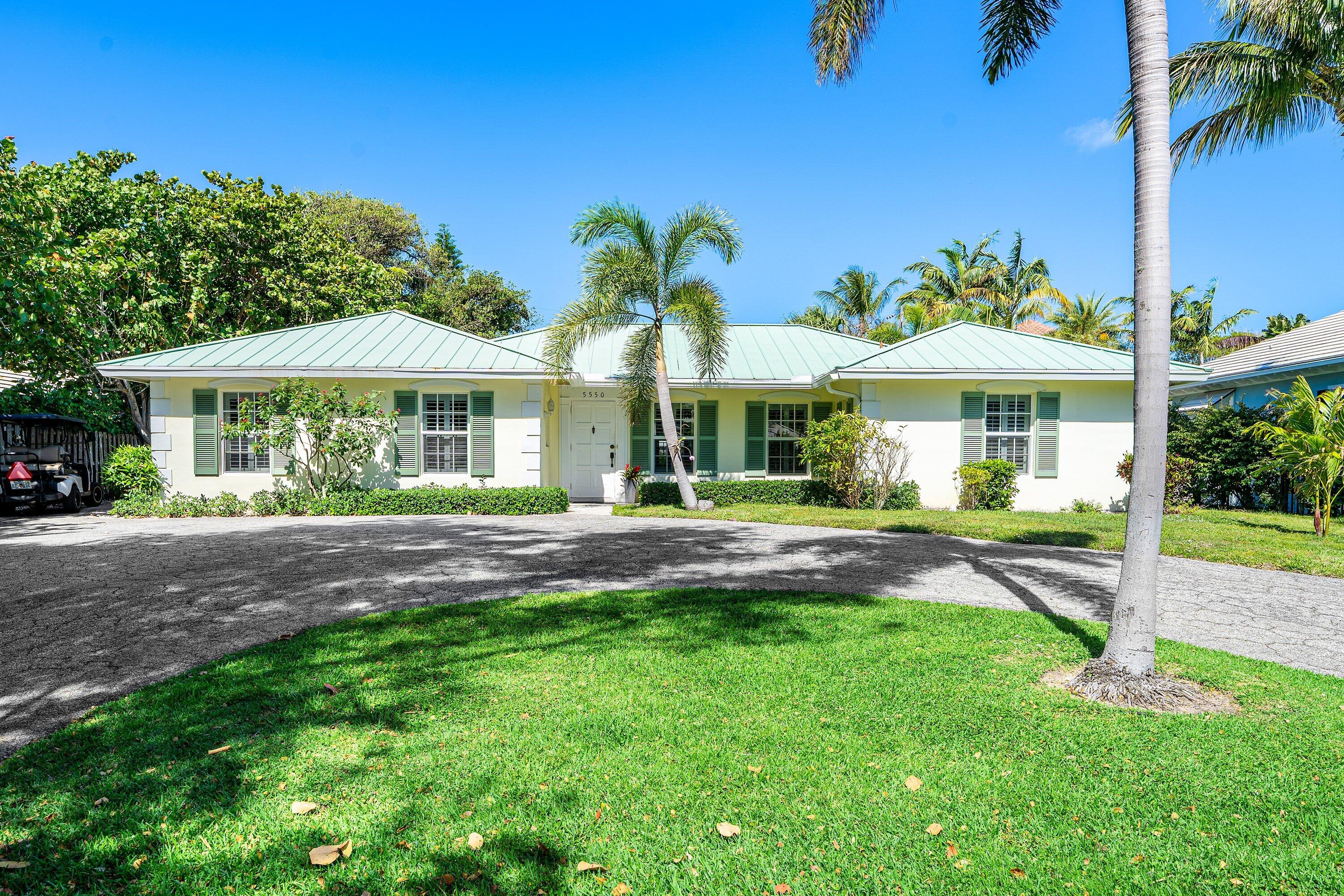 5550 Osprey Drive Ocean Ridge, FL 33435 - Photo 4 of 44 a view of a house with a yard and palm tree