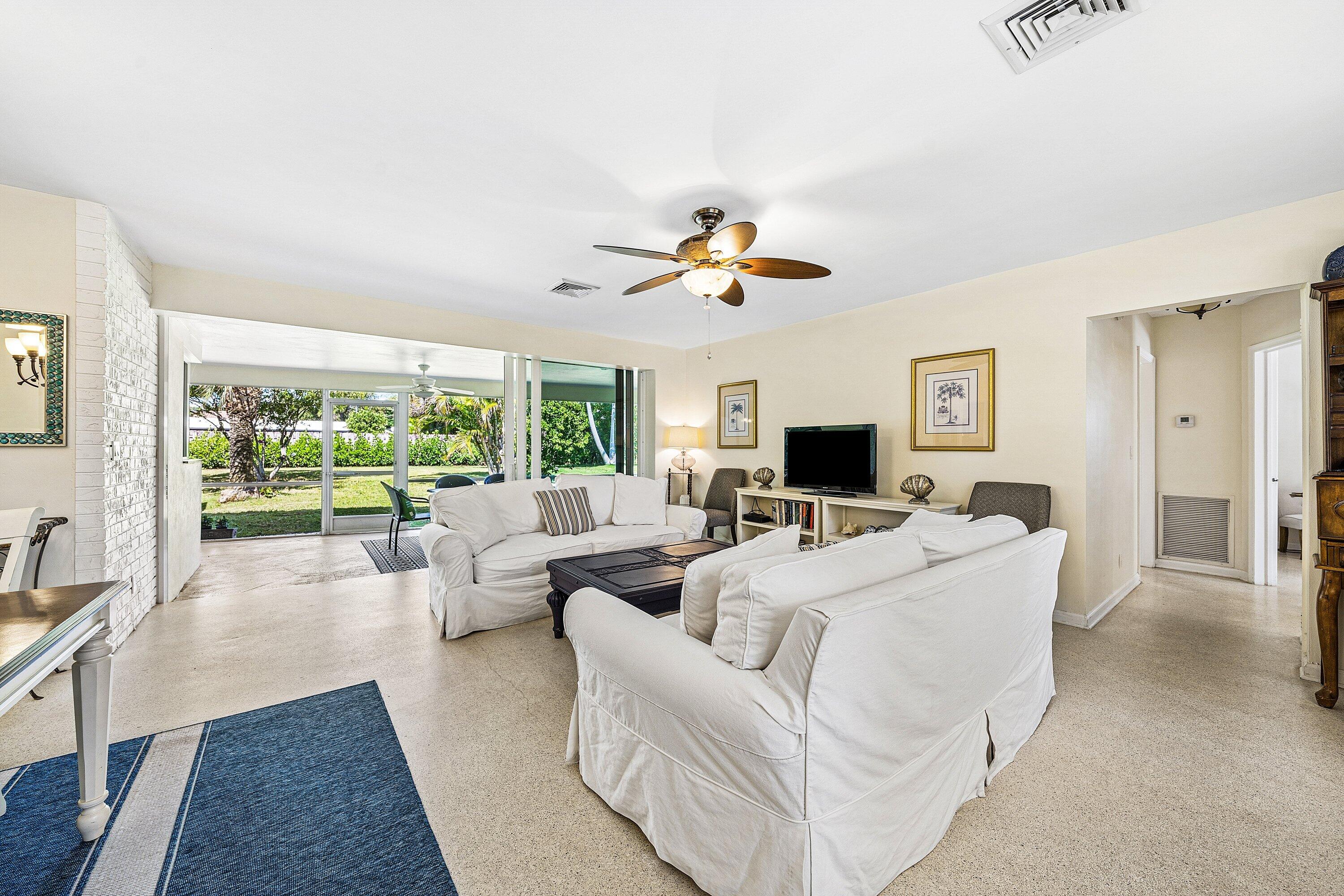 5550 Osprey Drive Ocean Ridge, FL 33435 - Photo 8 of 44 a living room with furniture ceiling fan and a large window