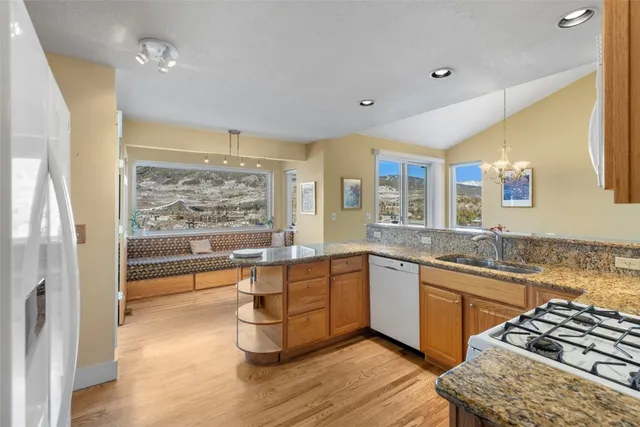 a large kitchen with a large window and stainless steel appliances