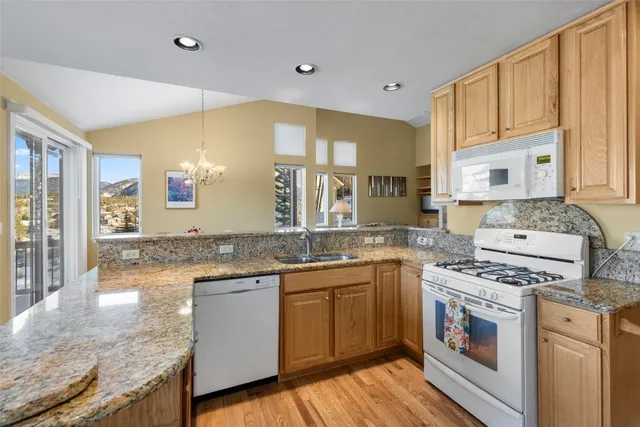 a kitchen with stainless steel appliances granite countertop a stove and a sink