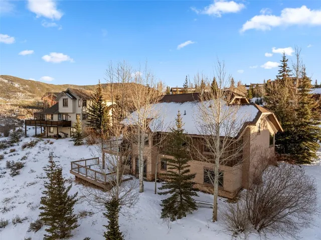 a view of a house with a yard covered with snow