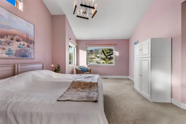 a spacious bedroom with a bed and a large window