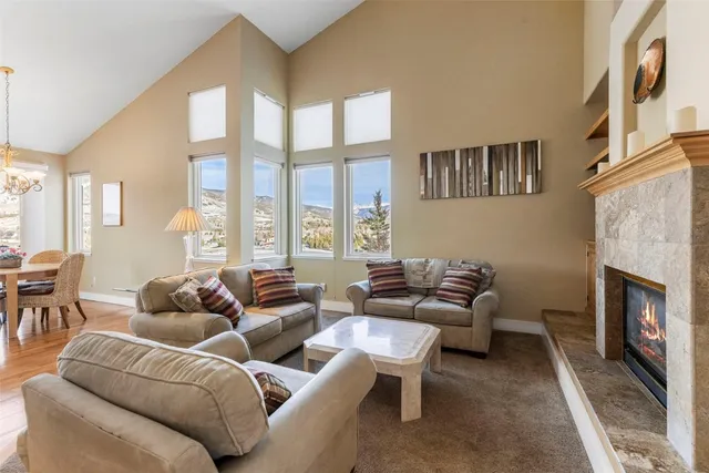 a living room with furniture fireplace and a large window