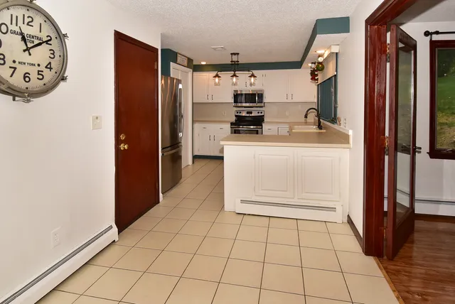 a kitchen with stainless steel appliances a refrigerator and cabinets