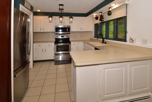 a kitchen with a sink appliances and cabinets