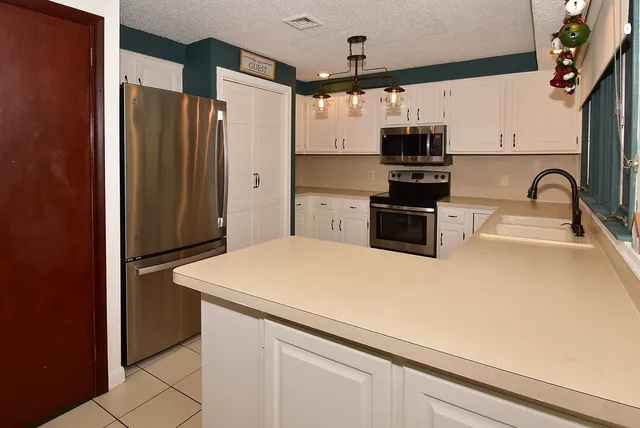 a kitchen with stainless steel appliances a refrigerator stove and sink