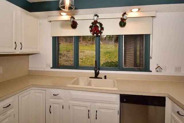 a kitchen with a sink and a window