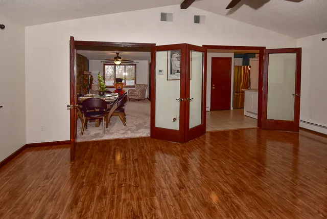 a view of a living room and hallway with wooden floor