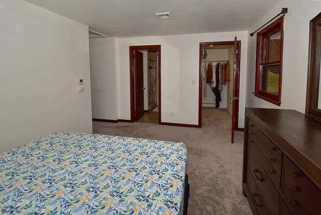 a bedroom with a bed and a dresser