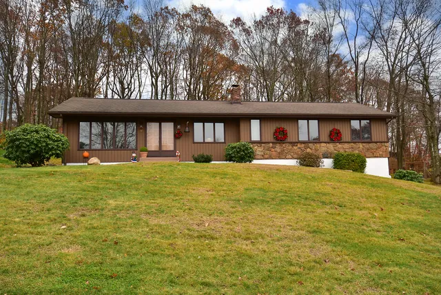 a front view of a house with garden