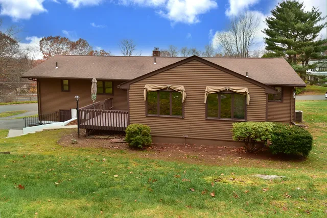 a backyard of a house with table and chairs