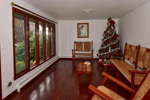 a living room with furniture fireplace and wooden floor