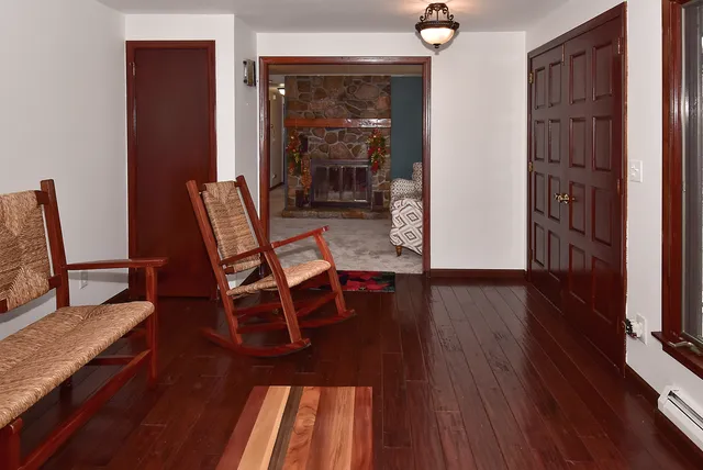 a dining room with furniture and wooden floor