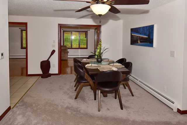 a dining room with furniture and window