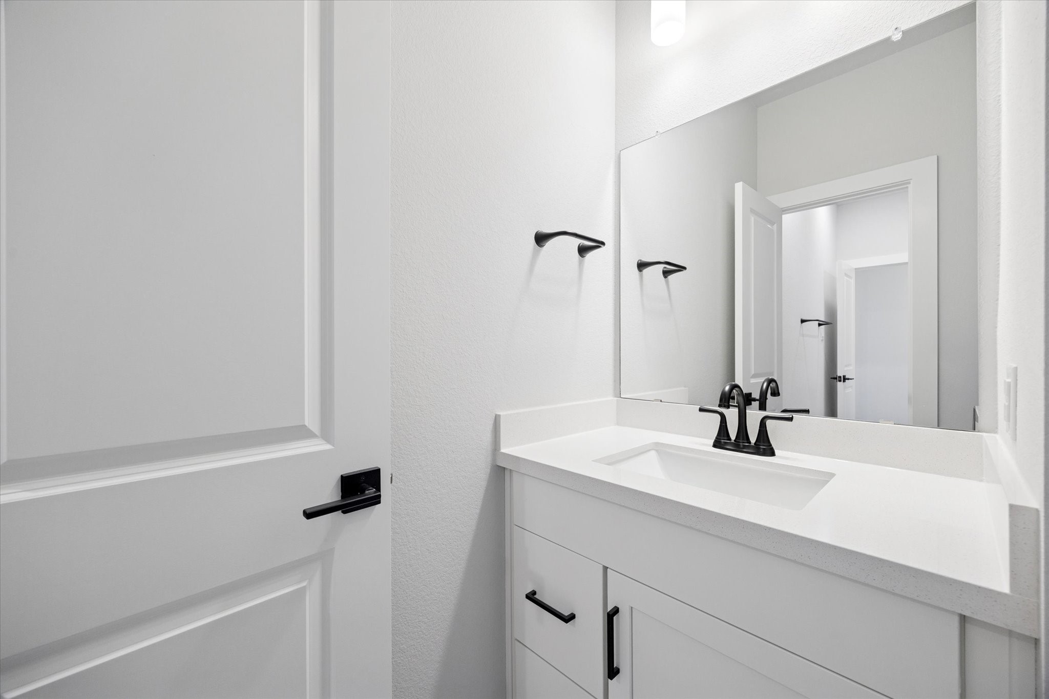 31435 Beacon Cove Trail Fulshear, TX 77441 - Photo 29 of 35 a bathroom with a sink and a mirror