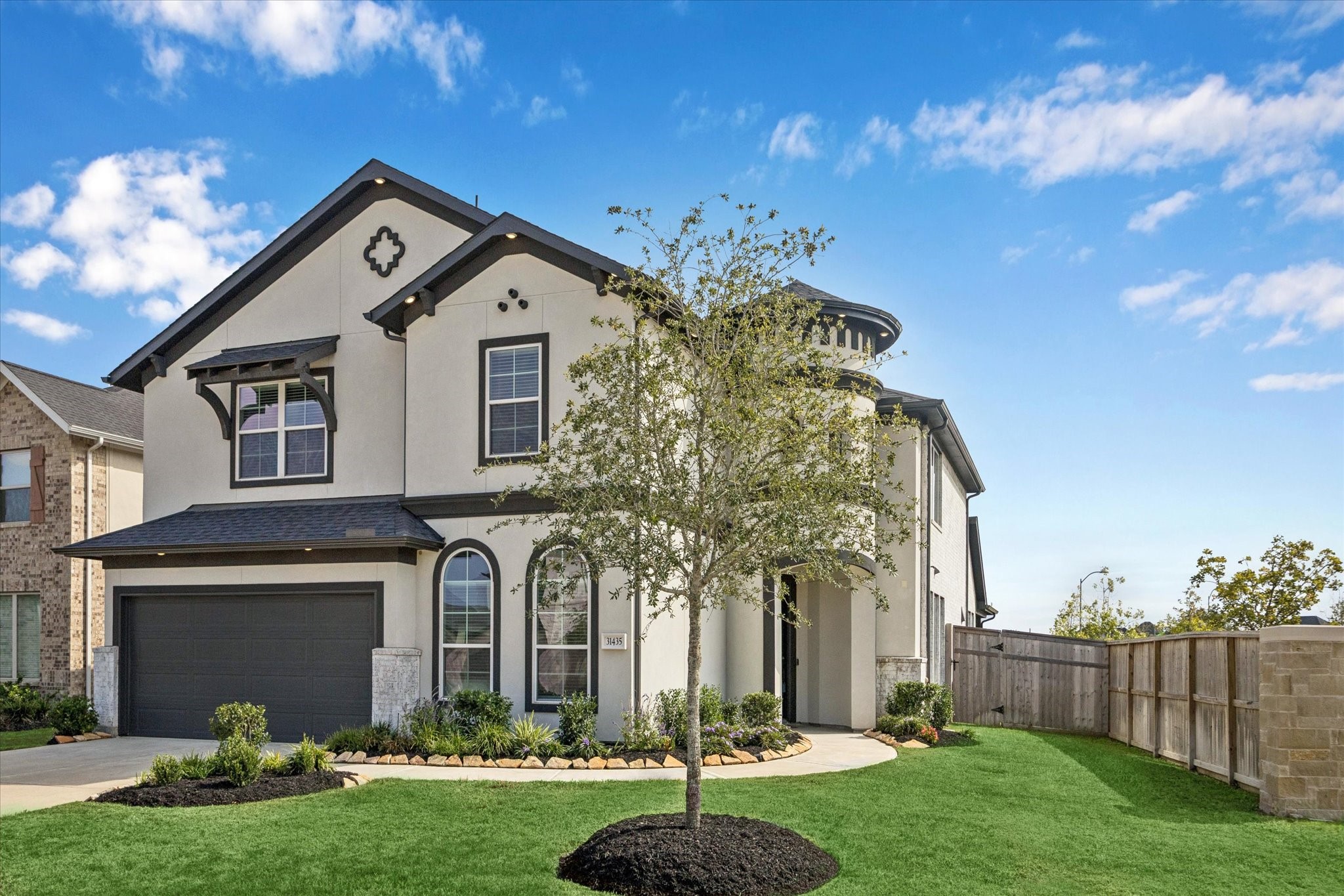 31435 Beacon Cove Trail Fulshear, TX 77441 - Photo 3 of 35 a front view of a house with garden