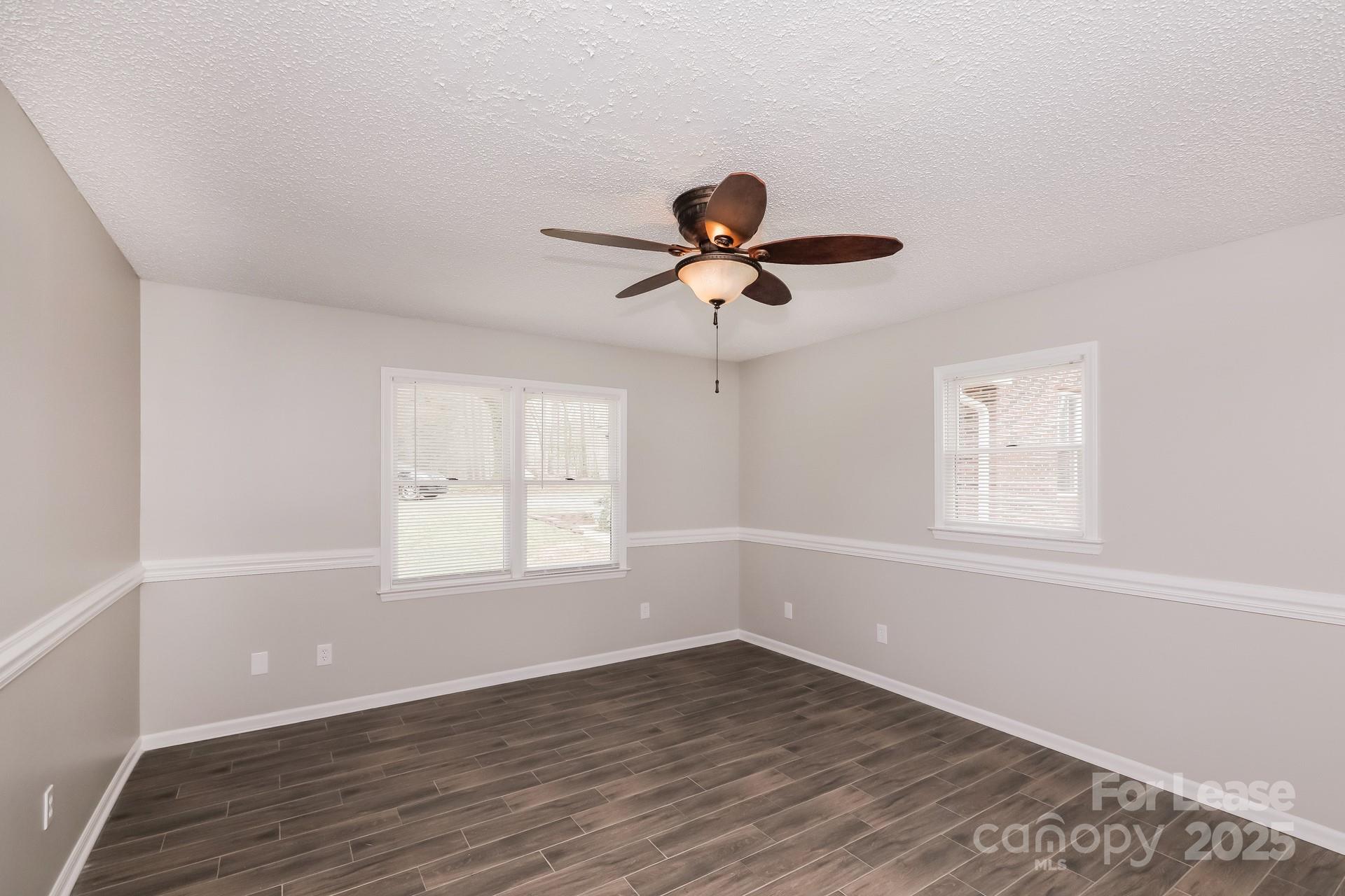 826 Potter Road Monroe, NC 28110 - Photo 12 of 17 a view of an empty room with wooden floor and a window