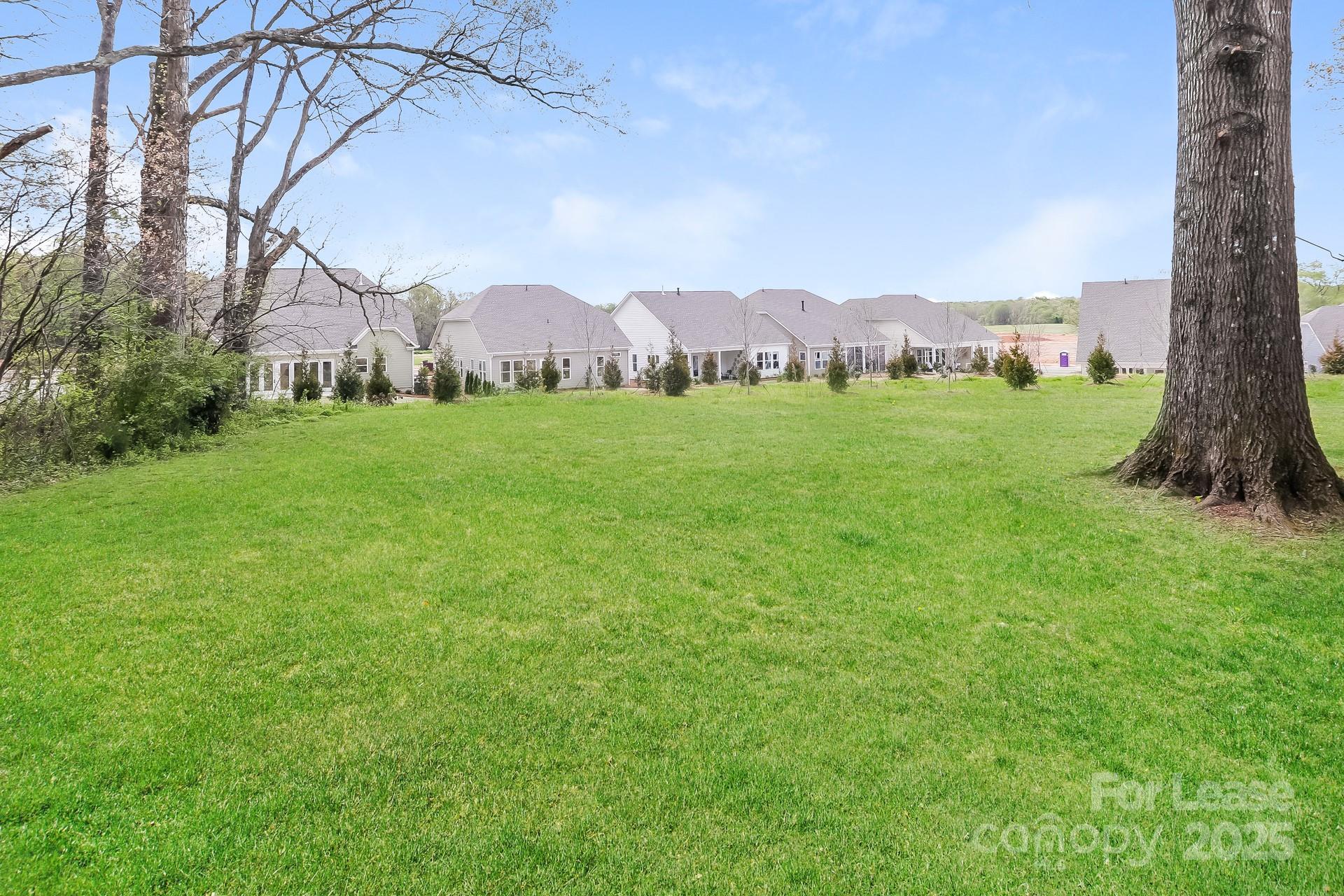 826 Potter Road Monroe, NC 28110 - Photo 16 of 17 a view of a lush green field
