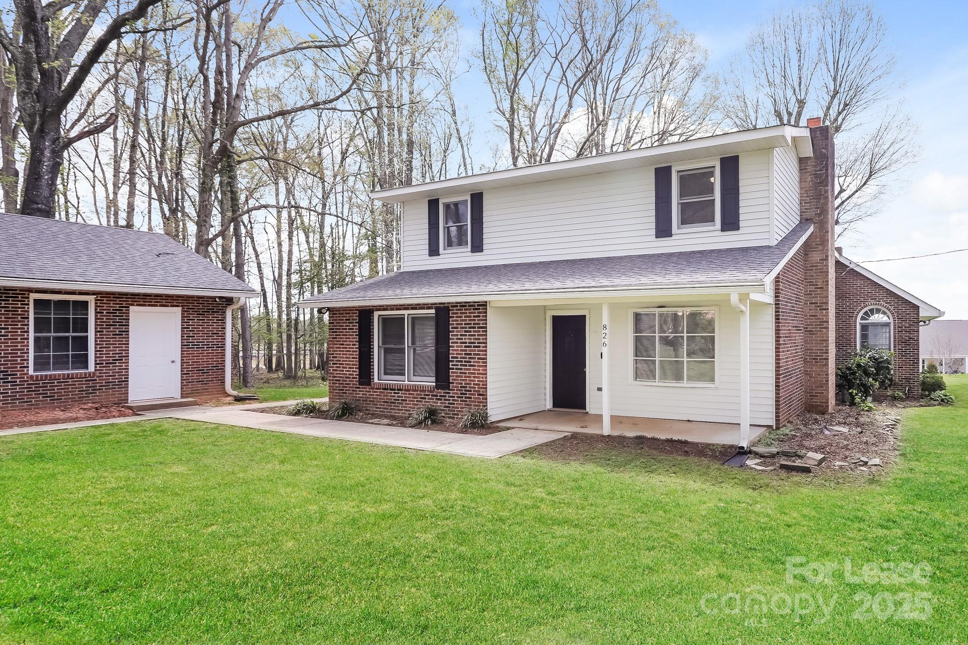 826 Potter Road Monroe, NC 28110 - Photo 2 of 17 a front view of a house with a yard and trees