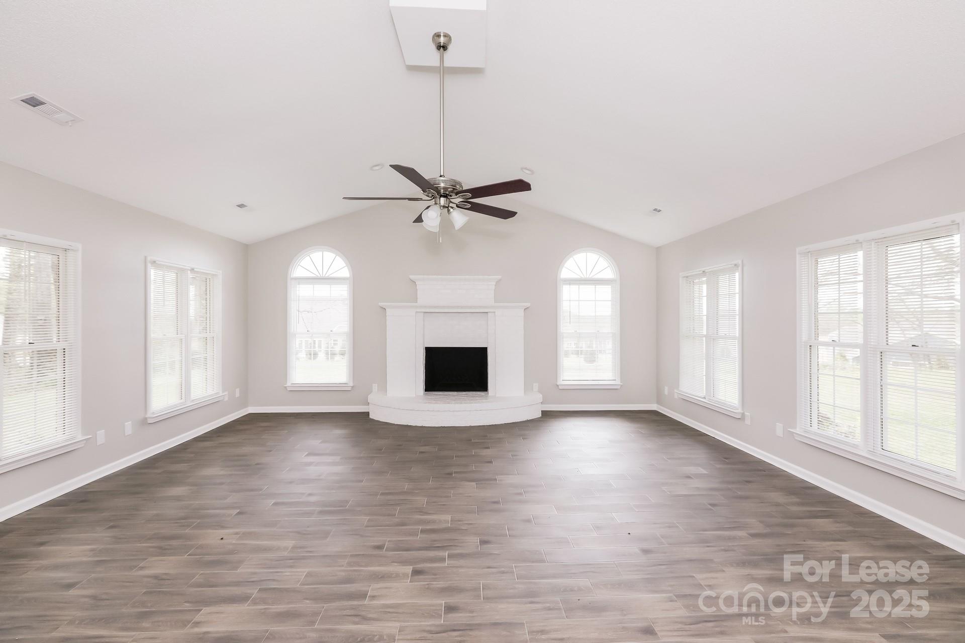 826 Potter Road Monroe, NC 28110 - Photo 5 of 17 a view of an empty room with a window and wooden floor