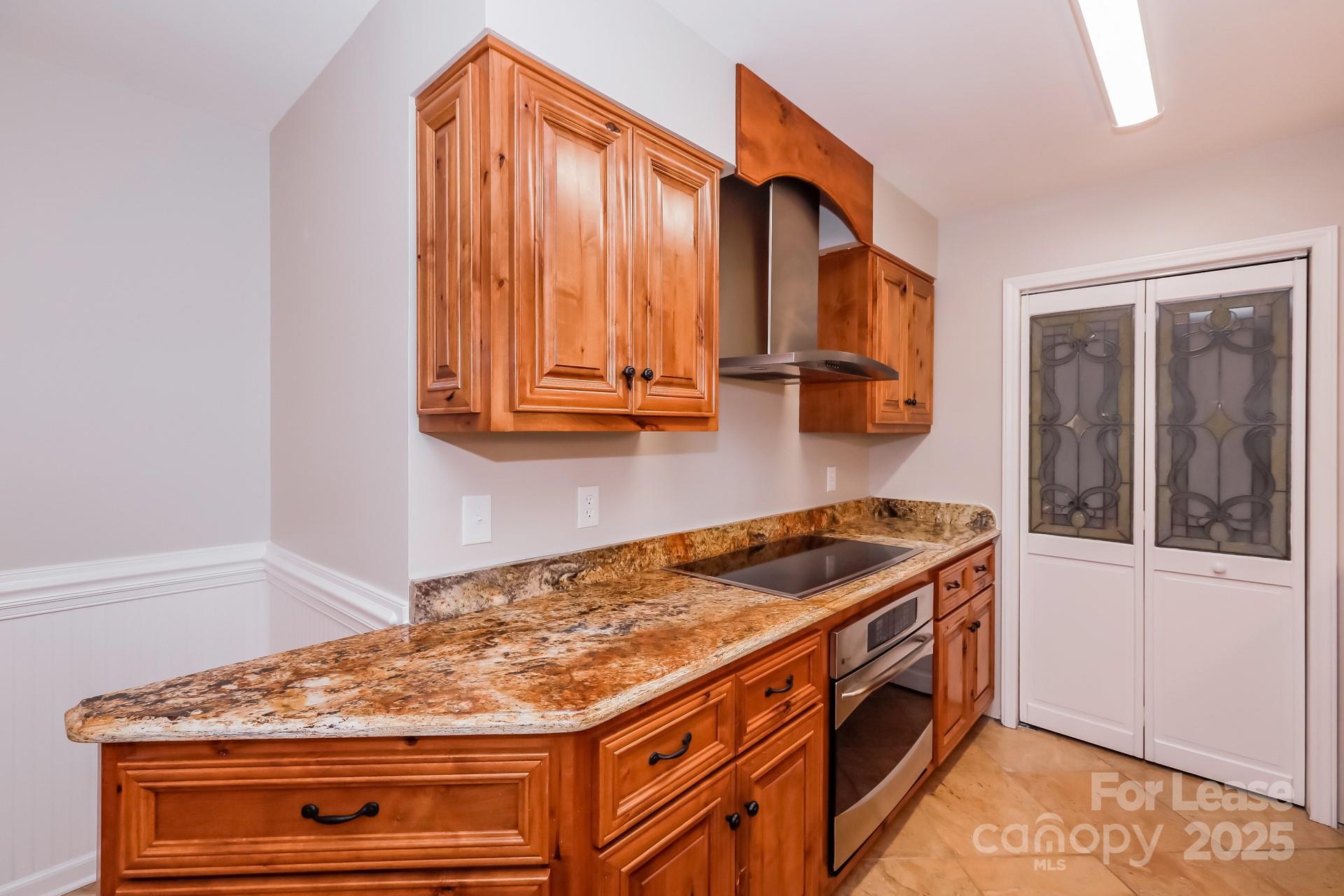 826 Potter Road Monroe, NC 28110 - Photo 7 of 17 a kitchen with granite countertop a stove and a cabinet