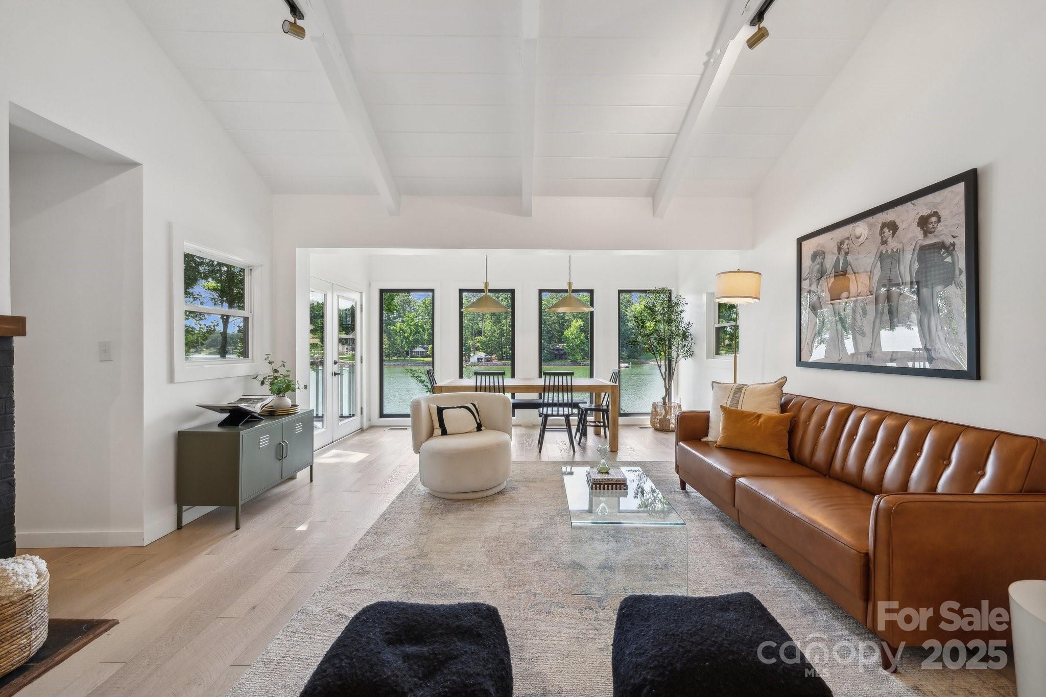 a living room with furniture and large windows