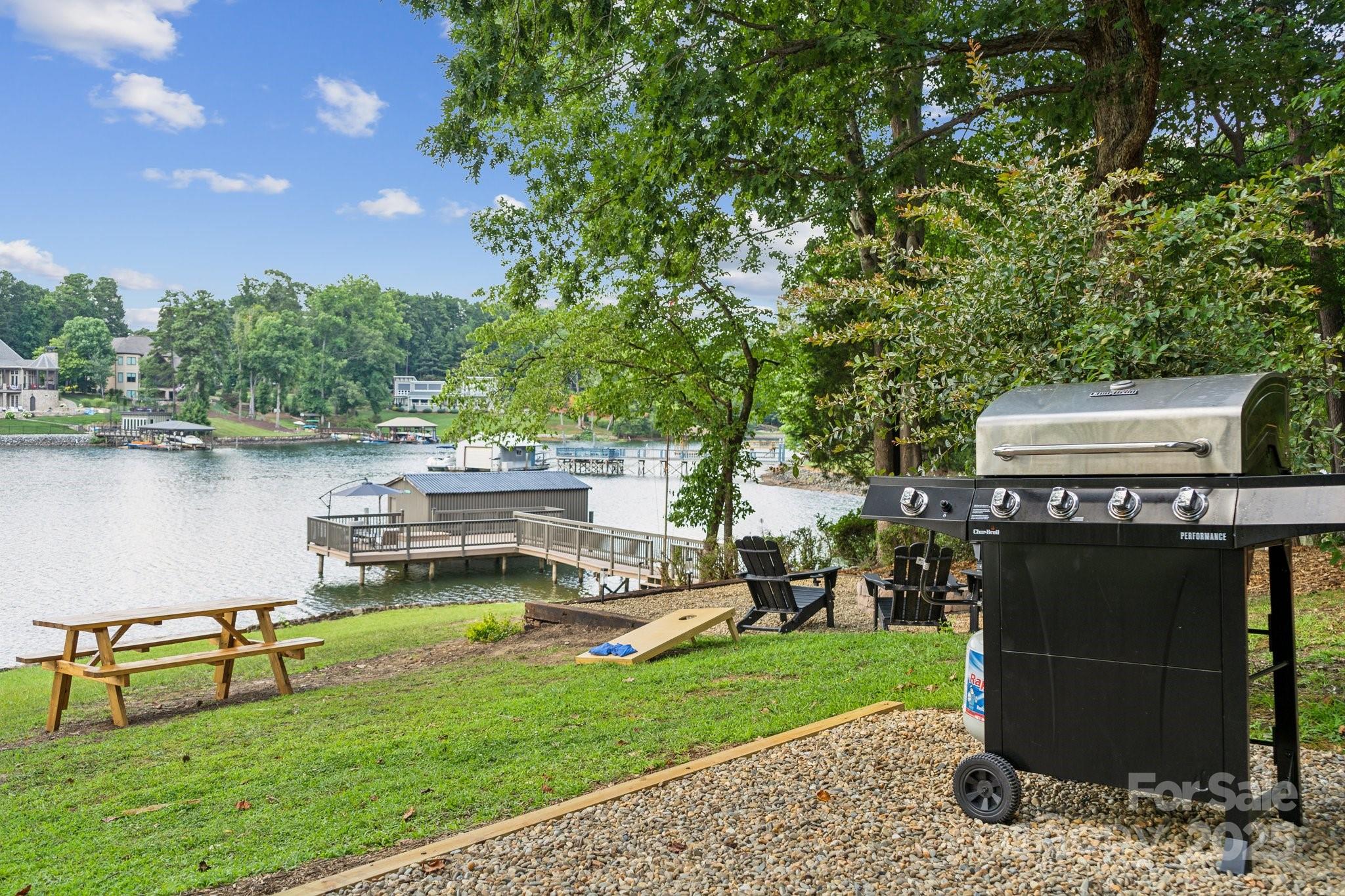 254 South Fork Road Mooresville, NC 28117 - Photo 22 of 34 a view of a lake with lawn chairs and a large tree