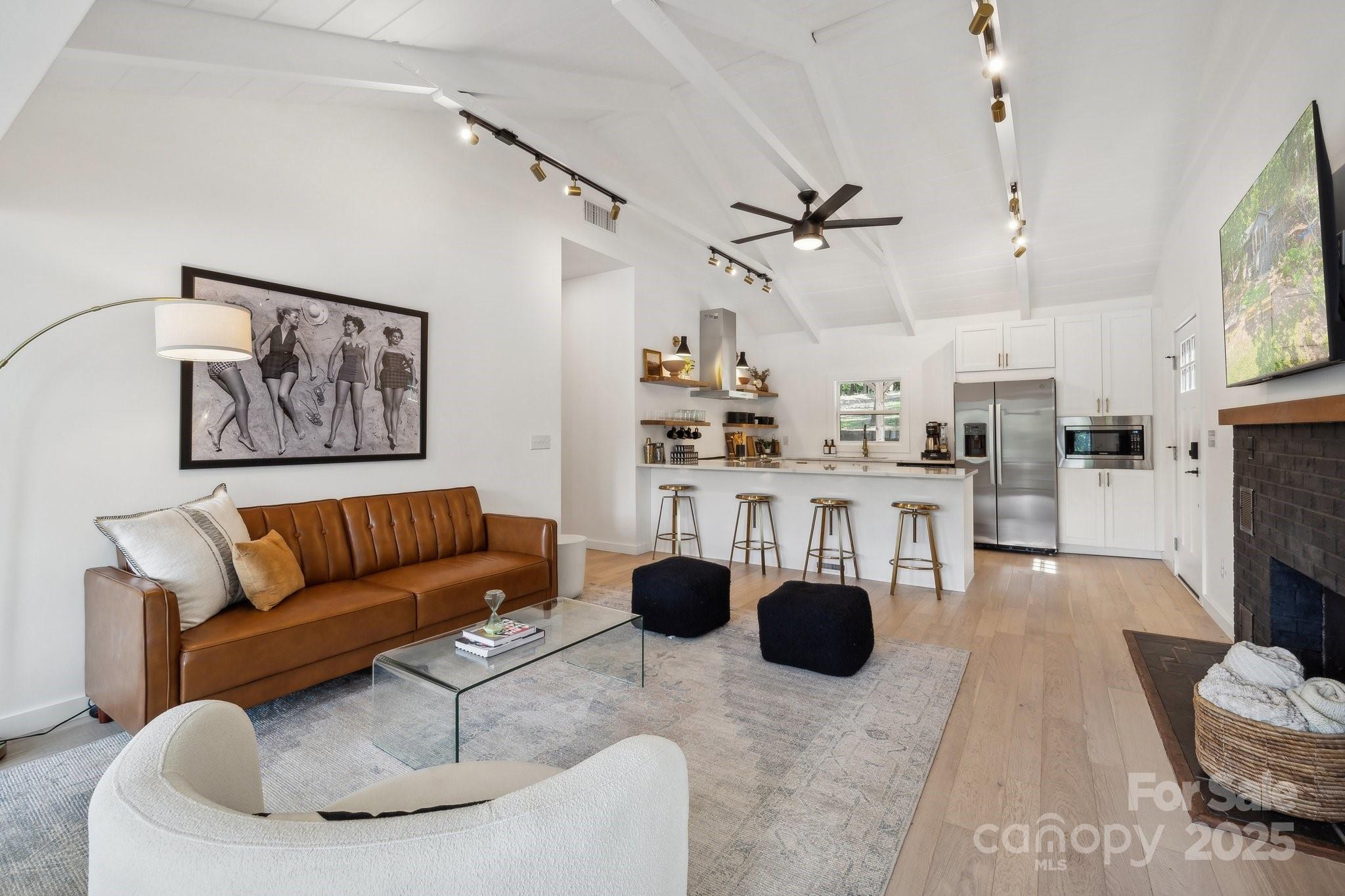254 South Fork Road Mooresville, NC 28117 - Photo 3 of 34 a living room with furniture a chandelier and a flat screen tv