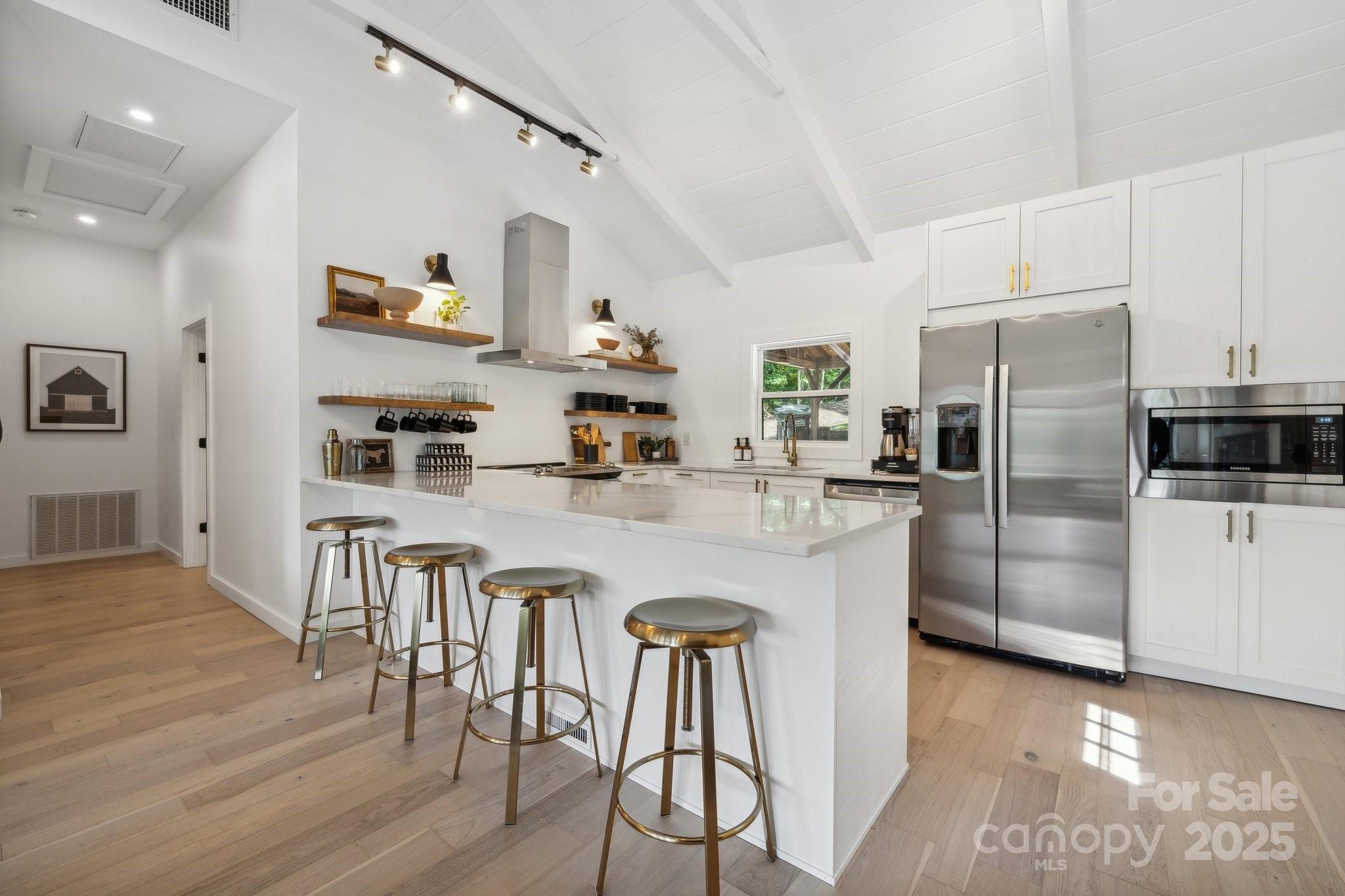 254 South Fork Road Mooresville, NC 28117 - Photo 5 of 34 a kitchen with stainless steel appliances granite countertop a refrigerator a stove and white cabinets with wooden floor