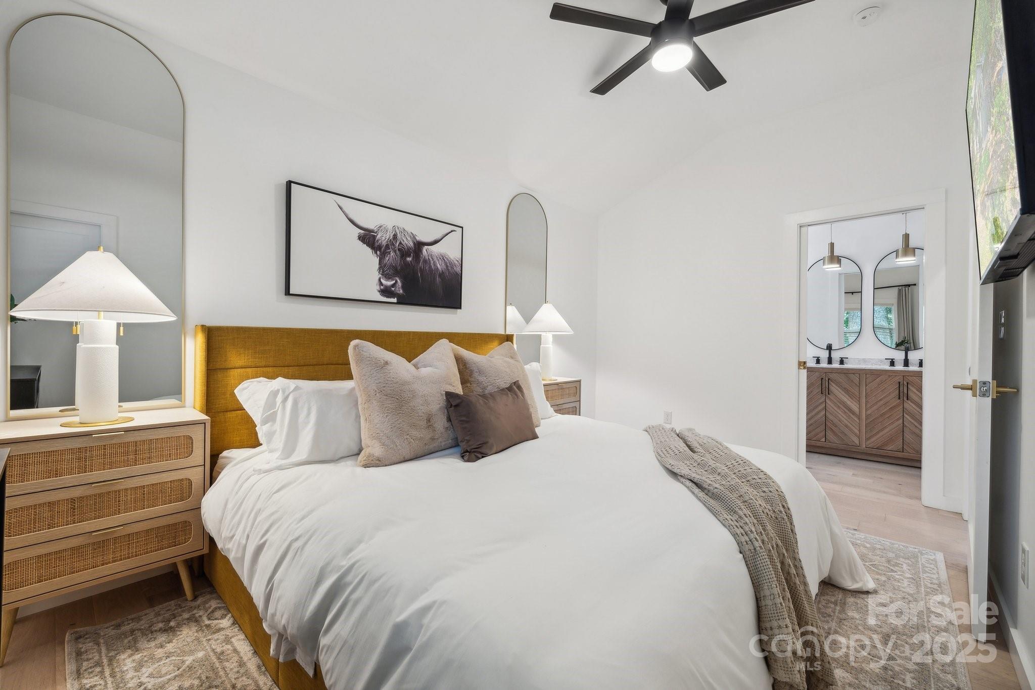 254 South Fork Road Mooresville, NC 28117 - Photo 9 of 34 a bedroom with a bed and a chandelier