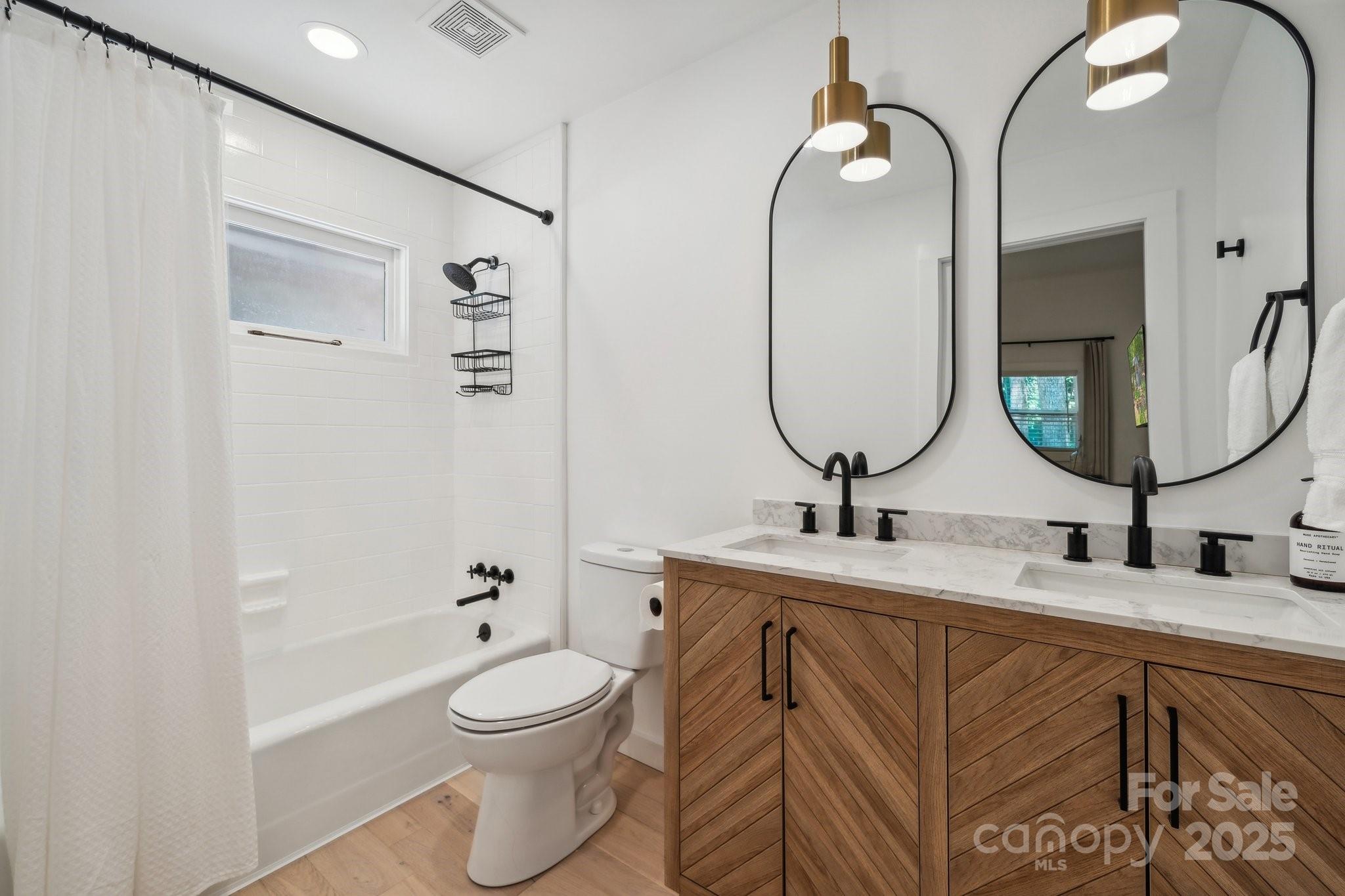254 South Fork Road Mooresville, NC 28117 - Photo 10 of 34 a bathroom with a toilet a sink and mirror