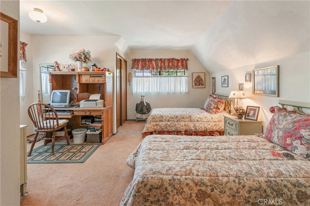 329 Grass Valley Road Lake Arrowhead, CA 92352 - Photo 14 of 31 a bedroom with a large bed and a chandelier
