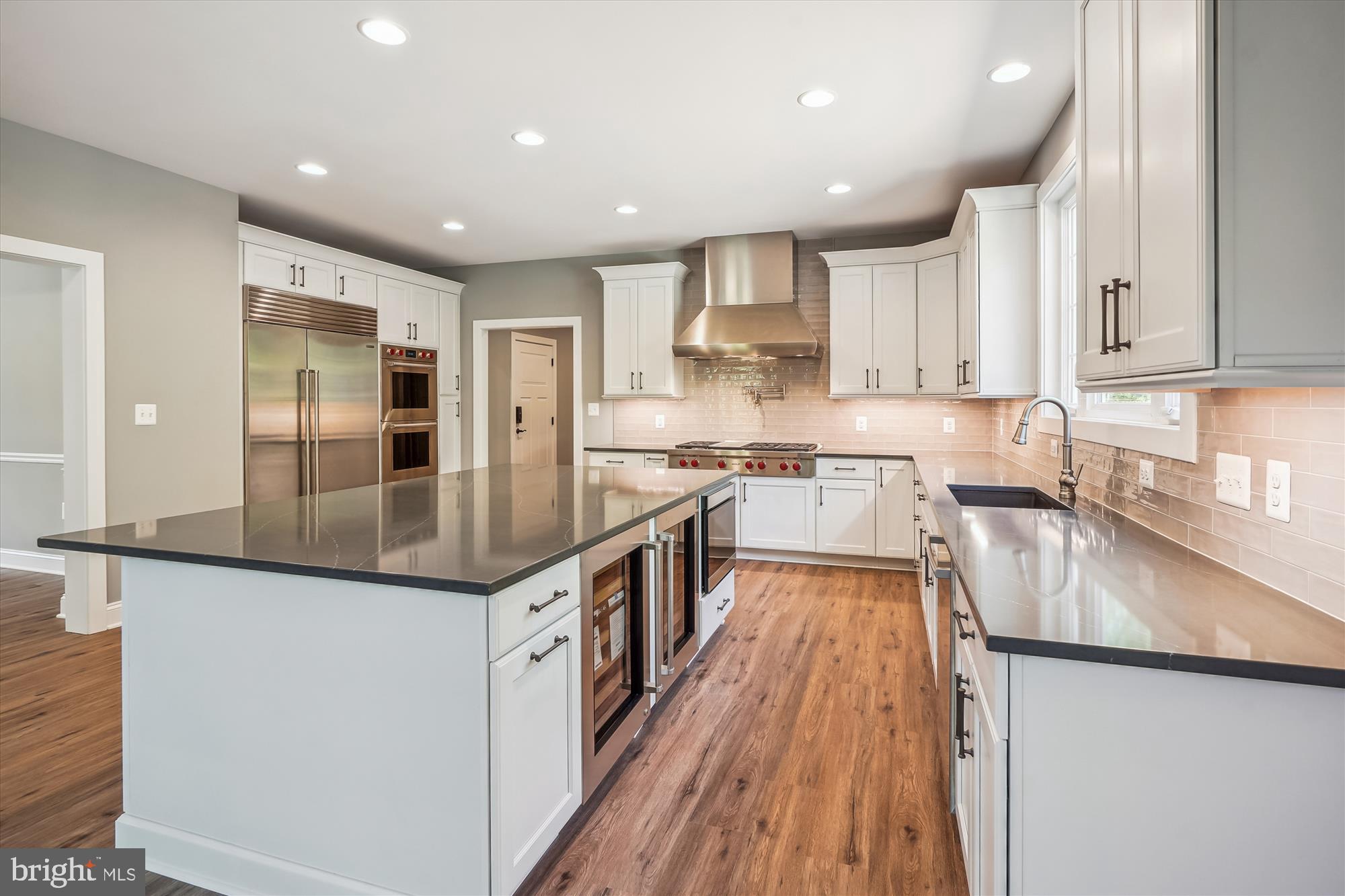 9336 Moses Place Culpeper, VA 22701 - Photo 23 of 50 a large kitchen with stainless steel appliances granite countertop a lot of counter space and wooden floors