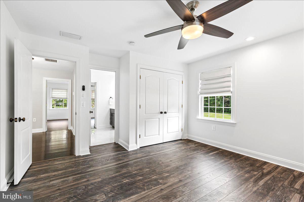102 Little Neck Road Stevensville, MD 21666 - Photo 45 of 77 a view of empty room with wooden floor and fan