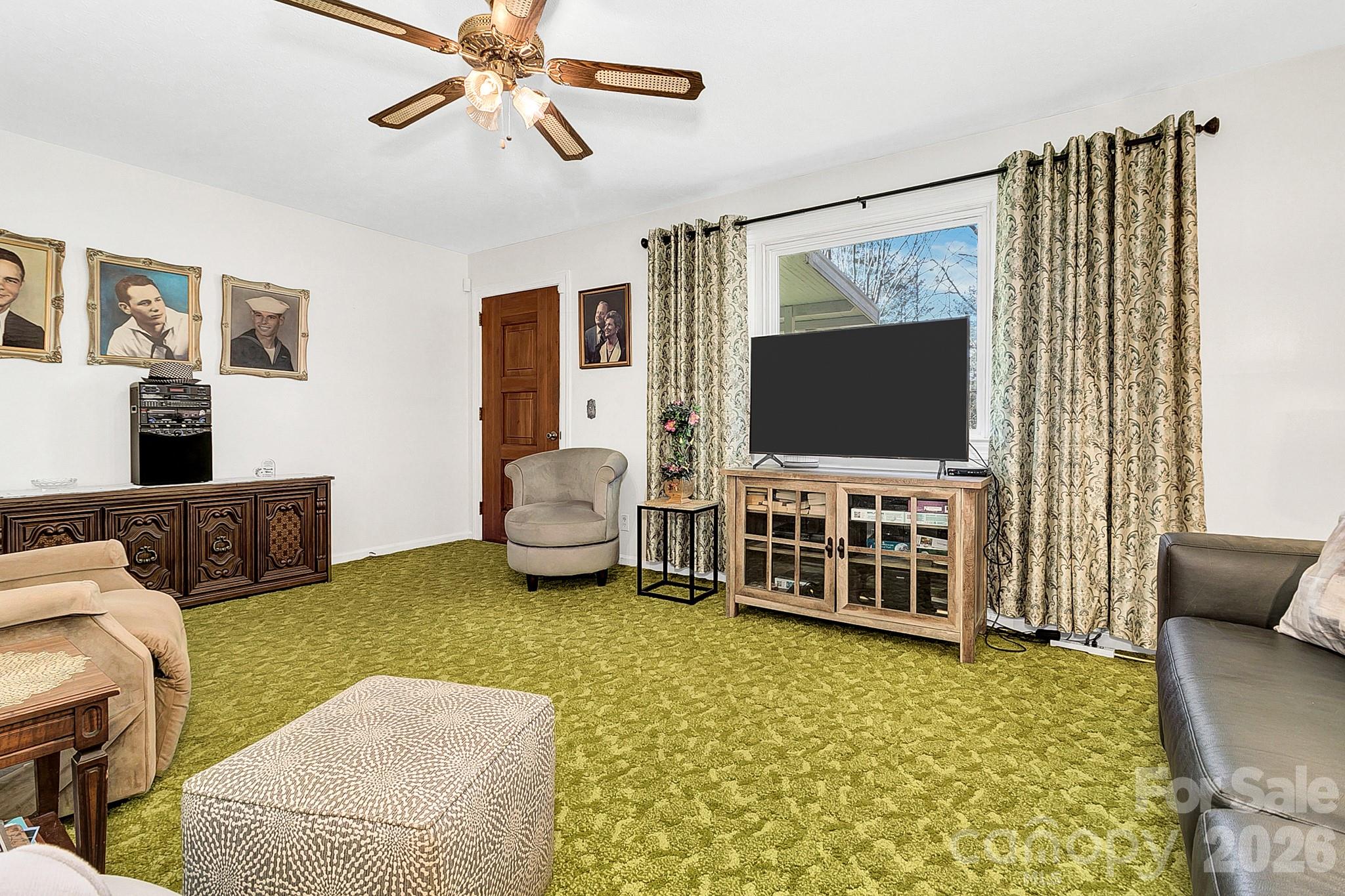 44 Tuttle Road Hendersonville, NC 28792 - Photo 15 of 37 a living room with furniture and a flat screen tv
