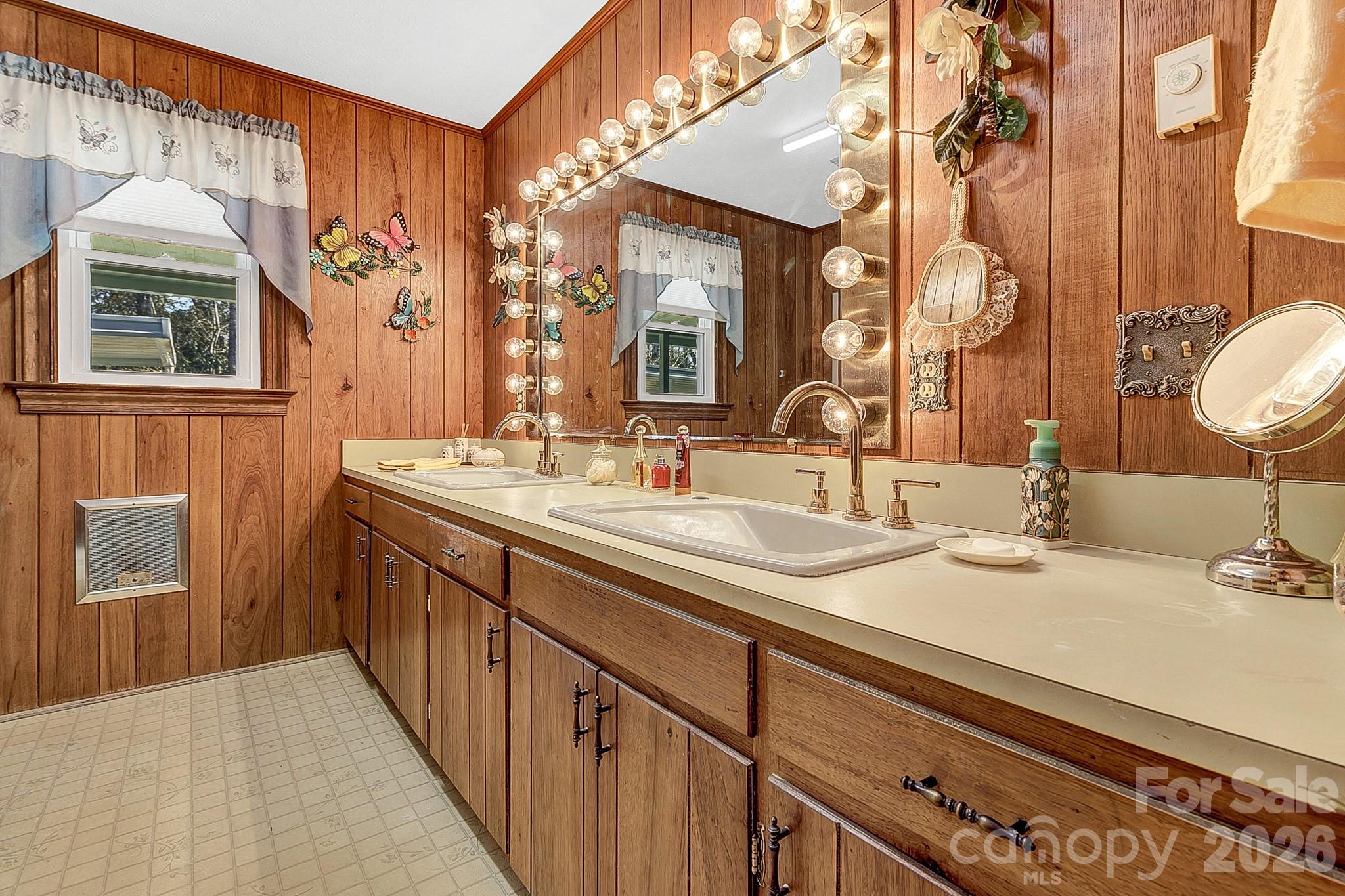 44 Tuttle Road Hendersonville, NC 28792 - Photo 18 of 37 a bathroom with a double vanity sink and a mirror