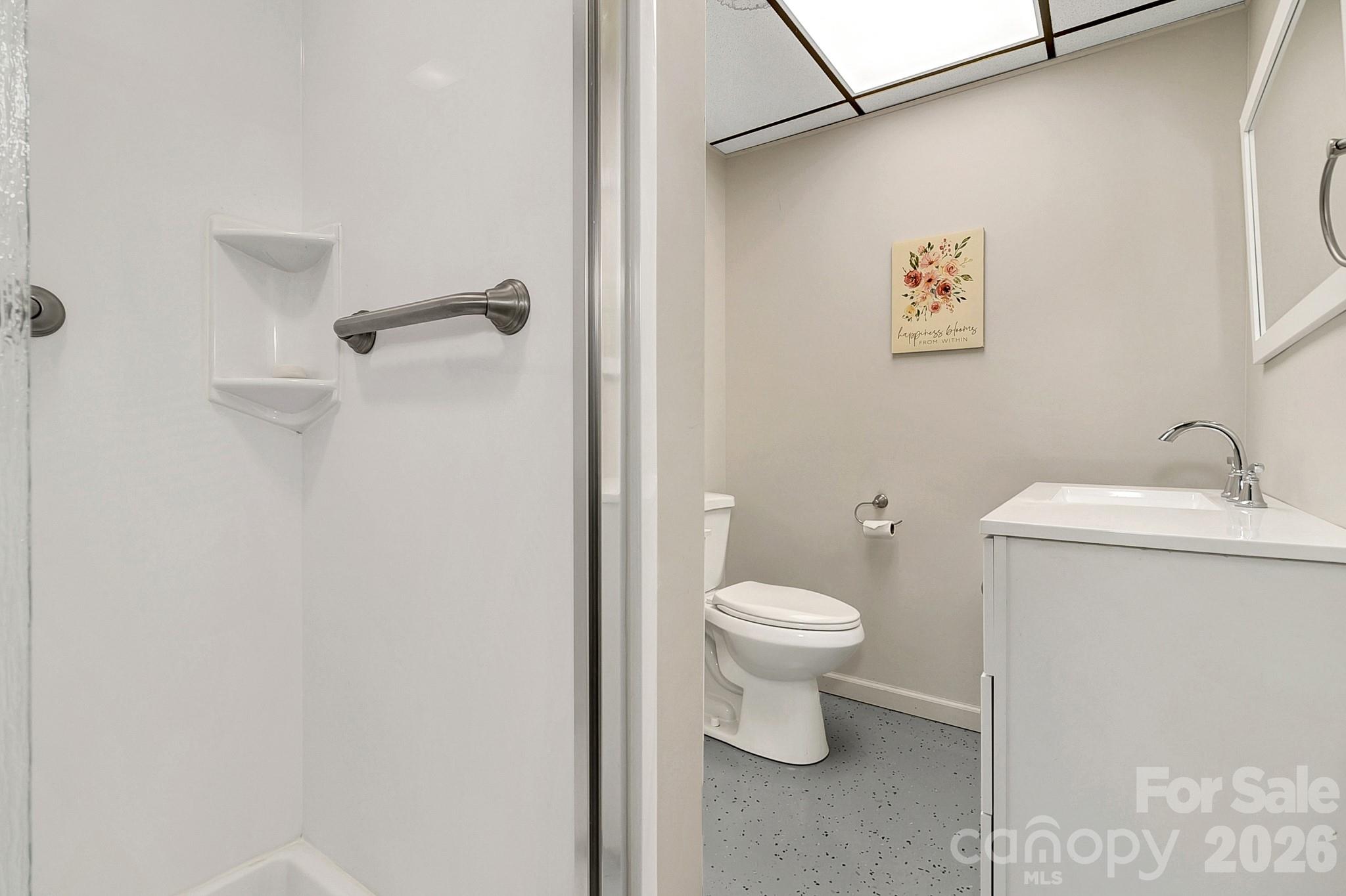 44 Tuttle Road Hendersonville, NC 28792 - Photo 24 of 37 a bathroom with a toilet sink and vanity