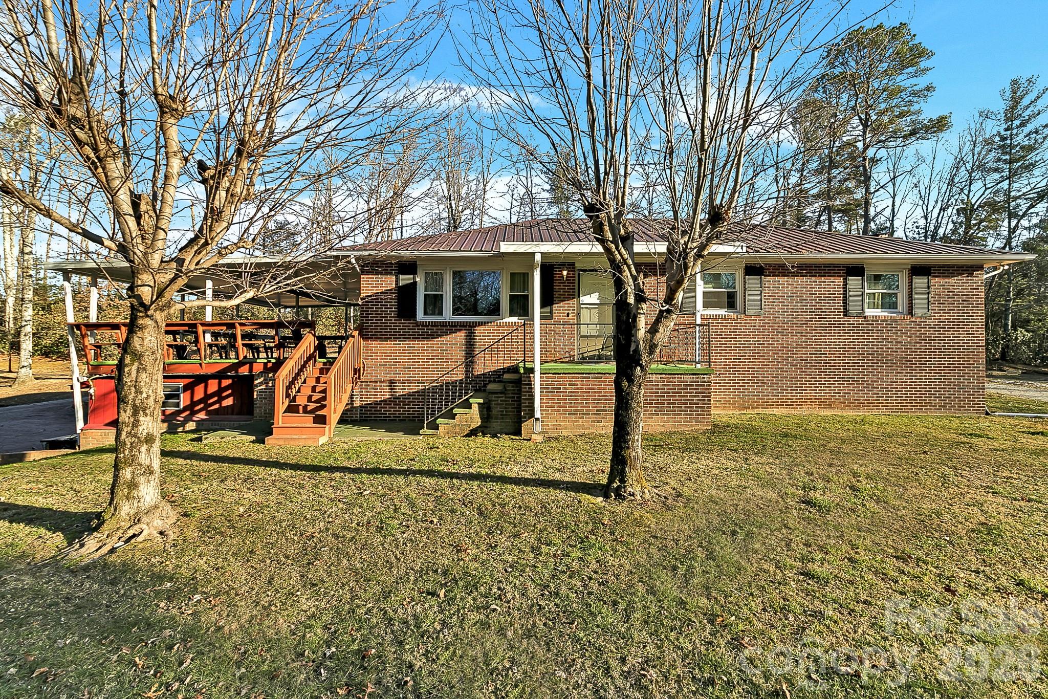 44 Tuttle Road Hendersonville, NC 28792 - Photo 3 of 37 a view of a yard with a house and trees