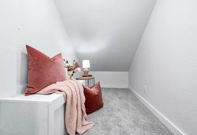 a bed room with a bed and a chair