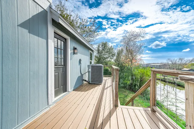 a balcony with wooden floor and fence