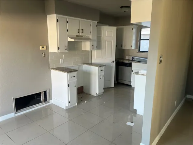 a utility room with cabinets washer and dryer