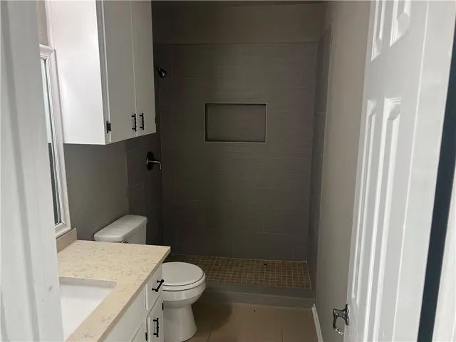 a white toilet sitting next to a bathroom sink