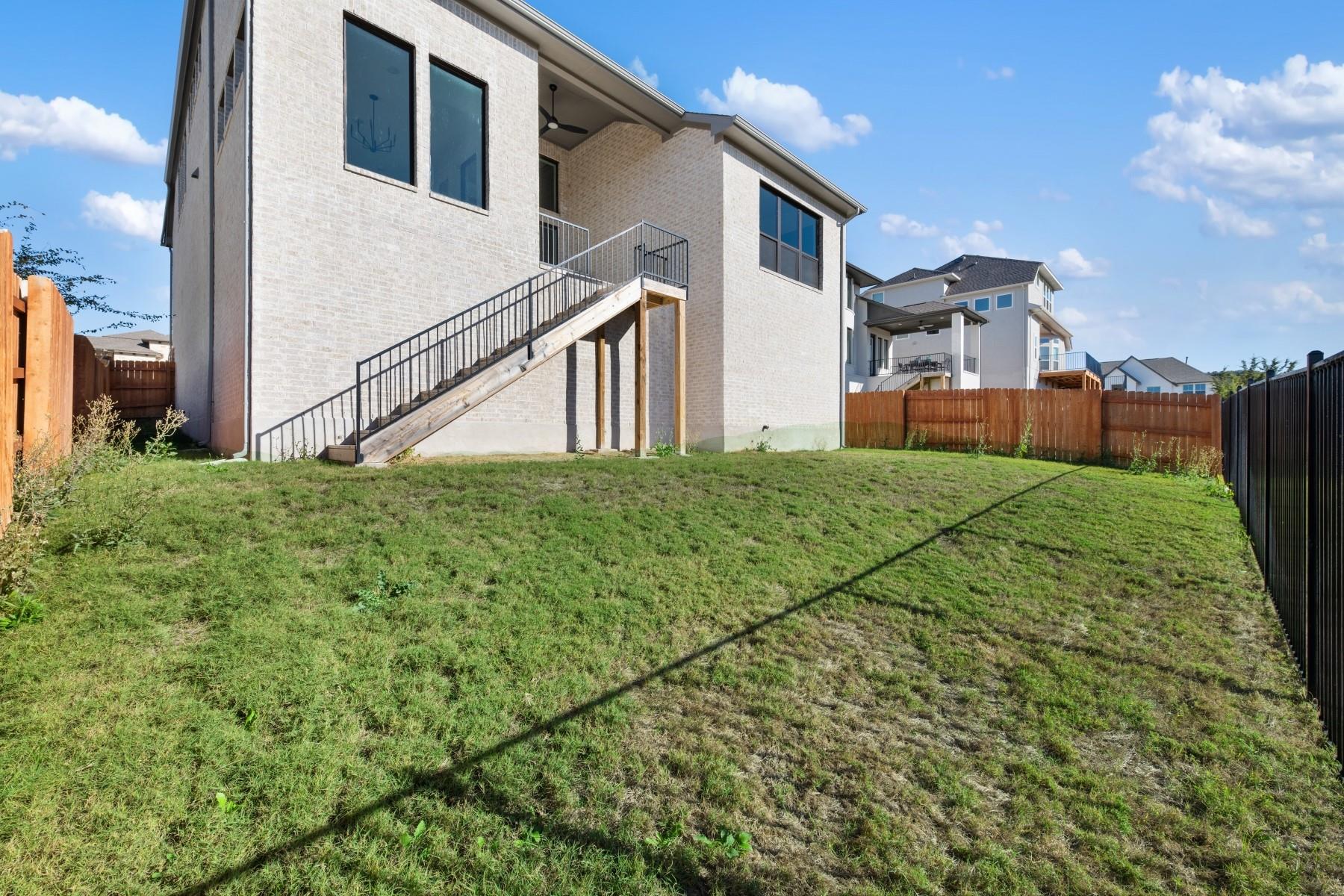 6216 Bower Well Road Austin, TX 78738 - Photo 30 of 31 a view of a house with a yard