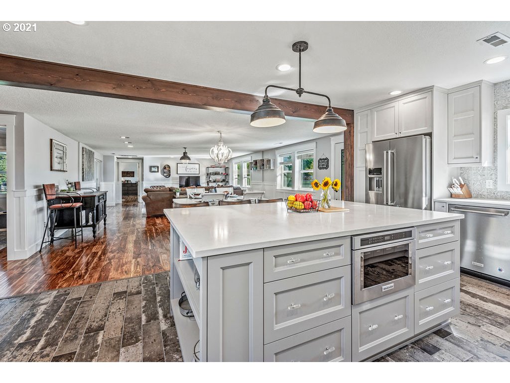 320 Northwest 194th Street Ridgefield, WA 98642 - Photo 12 of 32 a kitchen view with stainless steel appliances kitchen island granite countertop a sink and cabinets