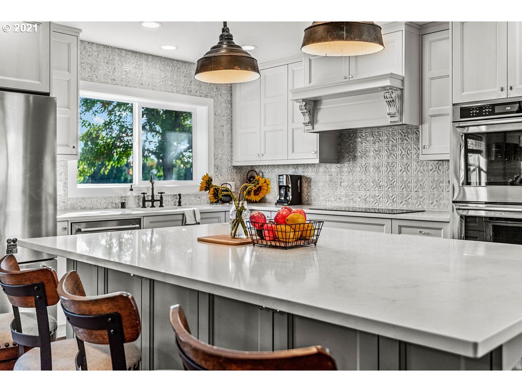 320 Northwest 194th Street Ridgefield, WA 98642 - Photo 13 of 32 a kitchen with stainless steel appliances a sink a table and chairs