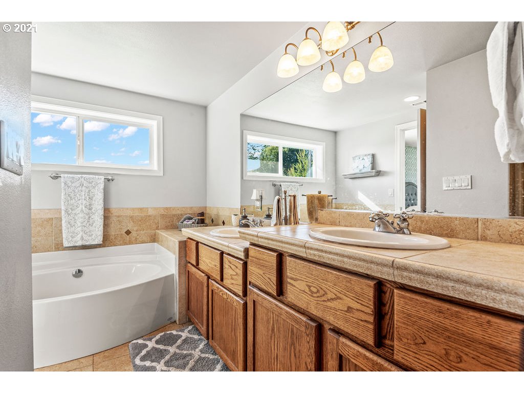 320 Northwest 194th Street Ridgefield, WA 98642 - Photo 22 of 32 a bathroom with a tub sink and mirror